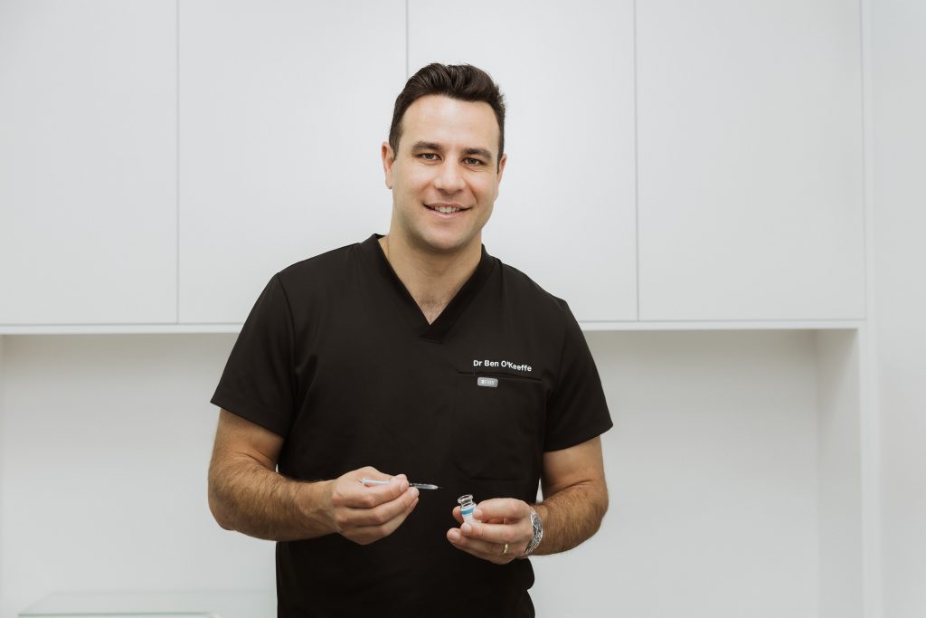 Dr Ben O'Keeffe in scrubs as a doctor